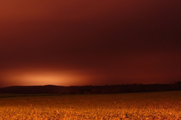 Night sky with an orange hue over a dark landscape. Text reads: "Aerosols Essential Climate Variable (ECV) Factsheet." Logos include GCOS, WMO, IOC, ISC, UNEP.