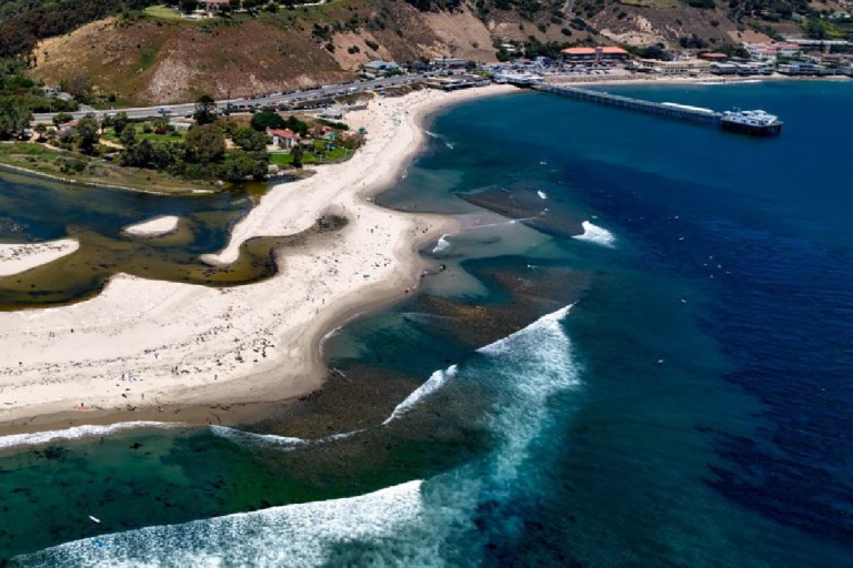 Aerial view of a coastal area with a factsheet about nitrous oxide overlayed on the left, associated with the Global Climate Observing System.