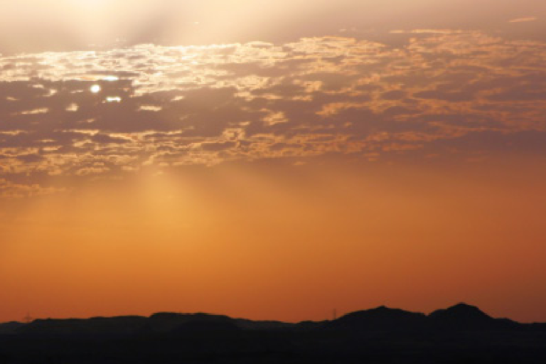 Cover of a factsheet titled "Surface Radiation Budget" by the Global Climate Observing System. Background shows a sunrise or sunset over a landscape.